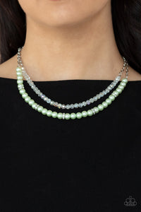 Parisian Princess - Green - Paparazzi Accessories -  Item #P2RE-GRXX-231XX A strand of glassy white crystal-like beads and pearly Green Ash beads and white rhinestone encrusted silver rings layer below the collar, creating a timeless display. Features an adjustable clasp closure.  Sold as one individual necklace. Includes one pair of matching earrings.