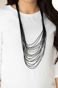 Nice CORD-ination - Black - Paparazzi Accessories -   Item #P2ST-BKXX-163XX Two rows of dainty silver beads and cylindrical rods are threaded along strands of shiny black cording that has been knotted in place, creating edgy rows across the chest. Features a magnetic closure.  Sold as one individual necklace. Includes one pair of matching earrings.