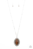 Exquisitely Enchanted - Brown - Paparazzi Accessories -  Item #P2RE-BNXX-264XX Dotted in glassy white rhinestones, leafy silver filigree blooms from an oversized brown cat's eye stone, creating an enchanted pendant at the bottom of a lengthened silver chain. Features an adjustable clasp closure.  Sold as one individual necklace. Includes one pair of matching earrings.