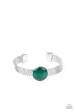 Mystical Magic - Green - Paparazzi Accessories -  Item #P9RE-GRXX-120XX A glassy green cat's eye stone frame sits atop a layered silver cuff that is etched in shimmery textures, creating a glittery centerpiece.  Sold as one individual bracelet.