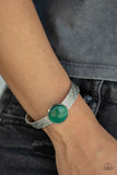 Mystical Magic - Green - Paparazzi Accessories -  Item #P9RE-GRXX-120XX A glassy green cat's eye stone frame sits atop a layered silver cuff that is etched in shimmery textures, creating a glittery centerpiece.  Sold as one individual bracelet.