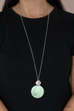 Tidal Tease - Green - Paparazzi Accessories -   Item #P2SE-GRXX-216XX Featuring a glistening iridescence, an Green Ash shell-like disc attaches to a shiny silver frame at the bottom of a lengthened silver chain, creating a summery pendant. Features an adjustable clasp closure.  Sold as one individual necklace. Includes one pair of matching earrings.