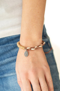 Perpetually Peaceful - Brown - Paparazzi Accessories -  Item #P9UR-BNXX-565XX Featuring a blooming dandelion, a simple silver disc is stamped in the word, "Peace," creating a whimsical charm on a homespun bracelet. Braided brown and white twine is balanced with wrapped brown twine for a natural feel encircling the wrist. Features an adjustable sliding knot closure.  Sold as one individual bracelet.