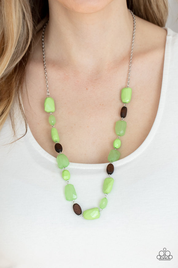 Meadow Escape - Green - Paparazzi Accessories -  Item #P2WH-GRXX-368XX Varying in opacity, a mixed assortment of faceted Apple Green beads delicately link with dainty wooden beads across the chest, creating a whimsically earthy display. Features an adjustable clasp closure.  Sold as one individual necklace. Includes one pair of matching earrings.