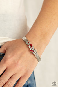 A Chic Clique - Red - Paparazzi Accessories -   Item #P9RE-RDXX-127XX A jumble of dazzling red and white rectangle-shaped rhinestones mingle with small red sparkling rhinestones atop a modern stamped silver cuff.  Sold as one individual bracelet.