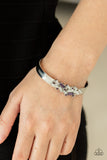 A Chic Clique - Purple - Paparazzi Accessories -  Item #P9RE-PRXX-138XX A jumble of dazzling purple and white rectangle-shaped rhinestones mingle with small purple sparkling rhinestones atop a modern stamped silver cuff.  Sold as one individual bracelet.