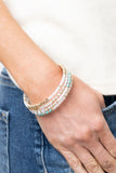 Infinitely Dreamy - Gold - Paparazzi accessories -   Item #P9ST-GDXX-039XX Sections of pearly white seed beads alternate with gold, turquoise, and crystal-like beads in infinite rows. The dreamy colors are threaded along a continuous strand of wire for an infinity wrap-style bracelet around the wrist.  Sold as one individual bracelet.