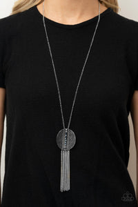 Radical Refinery - Blue - Paparazzi Accessories -  Item #P2ED-BLXX-042XX An oversized concave silver disc, ribbed with linear texture, creates a dramatic backdrop for a vertical row of faceted blue beads. A flirty tassel of delicate silver chains sways from the bottom of the pendant for a sassy finish at the bottom of a lengthened silver chain. Features an adjustable clasp closure.  Sold as one individual necklace. Includes one pair of matching earrings.