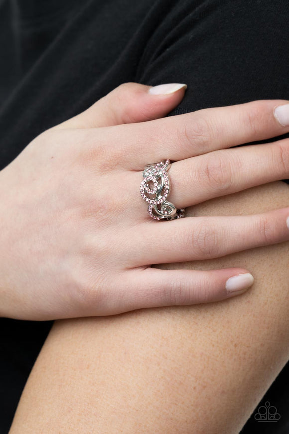 Melodic Motion - Pink - Paparazzi Accessories -   Item #P4RE-PKXX-232XX An ornamental silver scrollwork frame, adorned with dainty sparkling pink rhinestones travels across the finger in a melodic display. Features a dainty stretchy band for a flexible fit.  Sold as one individual ring.