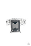 Social Glow - Silver - Paparazzi Accessories -  Item #P4ST-SVXX-002XX A smoky emerald cut gem is nestled inside a pronged silver frame atop a dainty silver band, creating a sparkly statement atop the finger. Features a dainty stretchy band for a flexible fit.  Sold as one individual ring.