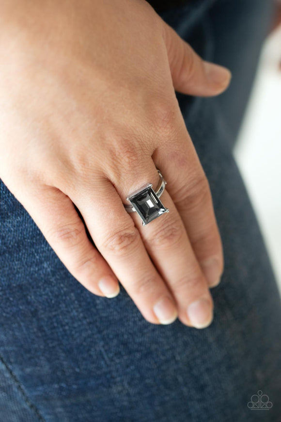 Social Glow - Silver - Paparazzi Accessories -  Item #P4ST-SVXX-002XX A smoky emerald cut gem is nestled inside a pronged silver frame atop a dainty silver band, creating a sparkly statement atop the finger. Features a dainty stretchy band for a flexible fit.  Sold as one individual ring.