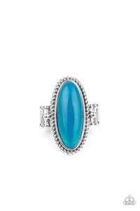 Oval Oasis - Blue - Paparazzi Accessories -  Item #P4ST-BLXX-005XX Featuring a glassy iridescence, an oval Blue Tint acrylic bead is pressed into the center of textured silver fittings, creating a mystical centerpiece atop the finger. Features a dainty stretchy band for a flexible fit.  Sold as one individual ring.
