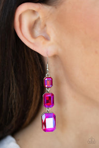 Cosmic Red Carpet - Pink - Paparazzi Accessories -  Item #P5RE-PKXX-236XX Featuring a dazzling pink UV shimmer, a trio of emerald-cut gems in graduating sizes is linked one below the other for a dramatic red carpet finish. Earring attaches to a standard fishhook fitting.  Sold as one pair of earrings.