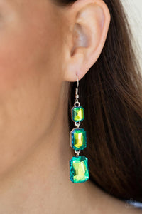 Cosmic Red Carpet - Green - Paparazzi Accessories -  Item #P5RE-GRXX-160XX Featuring a dazzling green and gold UV shimmer, a trio of emerald-cut gems in graduating sizes is linked one below the other for a dramatic red carpet finish. Earring attaches to a standard fishhook fitting.  Sold as one pair of earrings.