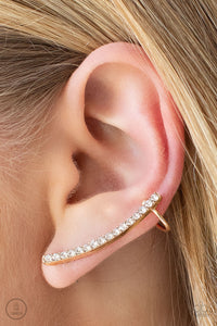 Give Me The SWOOP - Gold - Paparazzi Accessories -   Item #P5PO-CRGD-165XX A dainty row of glassy white rhinestones are encrusted along a glistening gold bar that swoops up the ear for a sparkly style. Features a dainty cuff attached to the top for a secure fit.  Sold as one pair of ear crawlers.