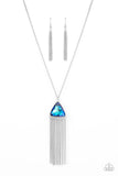 Item #P2RE-BLXX-334XX Featuring an iridescent UV shimmer, an oversized blue triangular gem swings from the bottom of a lengthened silver chain. A curtain of silver chains streams out from the bottom of the sparkly pendant, adding playful movement to the glamorous statement piece. Features an adjustable clasp closure.  Sold as one individual necklace. Includes one pair of matching earrings.