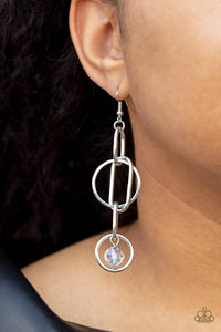 Park Avenue Princess - White - Paparazzi Accessories -  Item #P5RE-WTXX-550DO A collection of oval and round silver links, embellished with a faceted white bead suspended inside the bottom most round frame, coalesce into a flirty charm as it sways from the ear. Earring attaches to a standard fishhook fitting.  Sold as one pair of earrings.