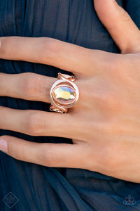 Mystical Treasure - Rose Gold - Paparazzi Accessories -   Item #P4RE-GDRS-249DV Interwoven rose gold bars delicately encircle an iridescent Pale Rosette gem, creating a mystical centerpiece atop the finger. Features a stretchy band for a flexible fit.  Sold as one individual ring.