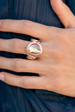 Mystical Treasure - Rose Gold - Paparazzi Accessories -   Item #P4RE-GDRS-249DV Interwoven rose gold bars delicately encircle an iridescent Pale Rosette gem, creating a mystical centerpiece atop the finger. Features a stretchy band for a flexible fit.  Sold as one individual ring.