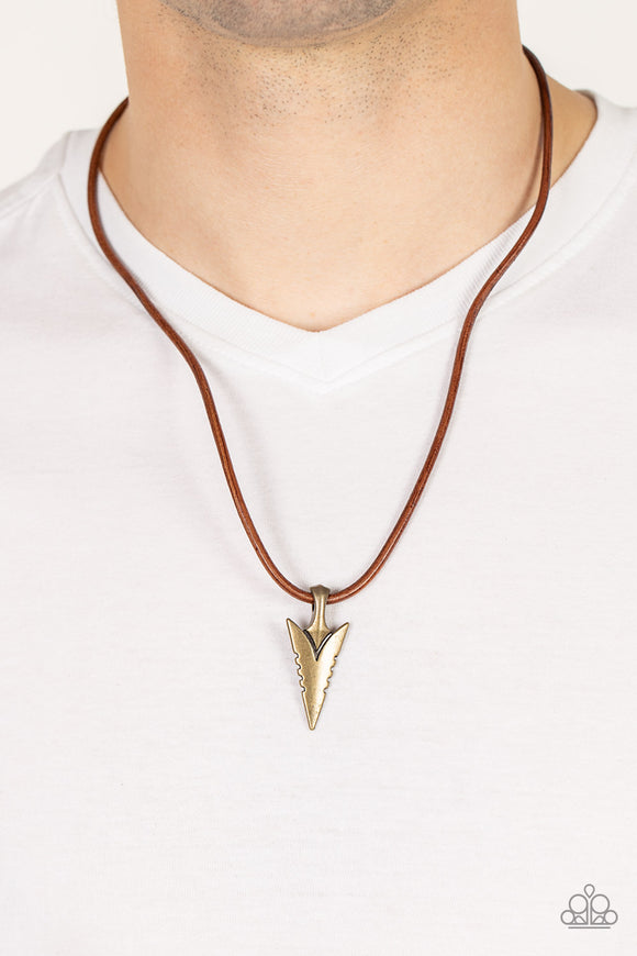 Pharaohs Arrow - Brass - Paparazzi Accessories -  Item #P2MN-URBR-020XX A brass arrowhead inspired pendant glides along a leathery brown cord below the collar, creating authentic edge. Features an adjustable clasp closure.  Sold as one individual necklace.