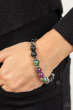 Mega Metamorphic - Multi - Paparazzi Accessories -  Item #P9SE-URMT-229XX Infused with a section of polished black beads, a stellar assortment of oil spill beads, silver accents, and black lava rock beads are threaded along stretchy bands around the wrist for an urban flair.  Sold as one individual bracelet.