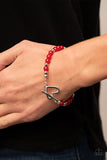 Following My Heart - Red - Paparazzi Accessories -  Item #P9WH-RDXX-172XX A shiny silver heart frame interlocks with a toggle closure at the center of a shiny silver and glassy red beaded bracelet. The silver toggle is stamped in the word, "love," for a romantic finish. Features a toggle closure.  Sold as one individual bracelet.