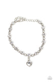 Truly Lovely - White - Paparazzi Accessories -  Item #P9WH-WTXX-237FD A white rhinestone heart charm dances from a strand of white rhinestones, resulting in a flirtatious sparkle around the wrist. Features an adjustable clasp closure.  Sold as one individual bracelet.