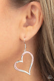 Tenderhearted Twinkle - Pink - Paparazzi Accessories -  Item #P5WH-PKXX-266XX A curvaceous silver heart is encrusted in sections of glittery pink rhinestones, invoking a flirtatious flair. Earring attaches to a standard fishhook fitting.  Sold as one pair of earrings.