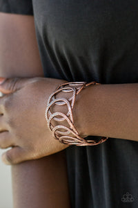 Circa de Contender - Copper - Paparazzi Accessories -  Etched and hammered in linear and diamond-cut shimmer, glistening copper circles join into a dramatic cuff around the wrist.  Sold as one individual bracelet.