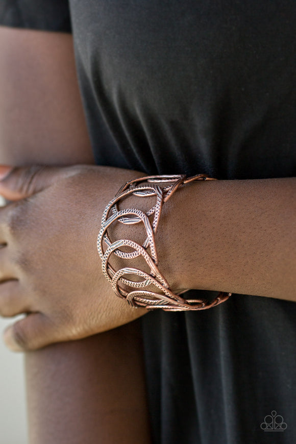 Circa de Contender - Copper - Paparazzi Accessories -  Etched and hammered in linear and diamond-cut shimmer, glistening copper circles join into a dramatic cuff around the wrist.  Sold as one individual bracelet.