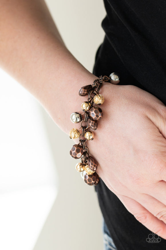 Invest In This - Multi - Paparazzi Accessories  Featuring shiny, faceted, and mesh finishes, mismatched copper, gold, and silver beads trickle from the wrist for an edgy industrial look. Features an adjustable clasp closure.  Sold as one individual bracelet.   Get The Complete Look! Necklace: 