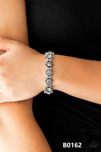 Strut Your Stuff - Silver - Paparazzi Accessories  Featuring smoky rhinestone centers, ornate silver frames are threaded along stretchy bands, linking across the wrist for a refined look.  Sold as one individual bracelet.