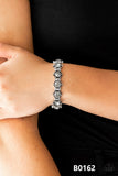 Strut Your Stuff - Silver - Paparazzi Accessories  Featuring smoky rhinestone centers, ornate silver frames are threaded along stretchy bands, linking across the wrist for a refined look.  Sold as one individual bracelet.