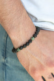 Enlivened - Green - Paparazzi Accessories  An earthy collection of black lava stones and green stones are threaded along a stretchy band around the wrist for a seasonal look.  Sold as one individual bracelet.