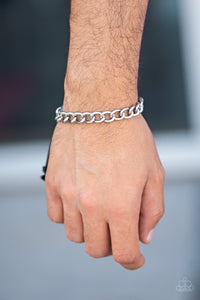 Sideline - Silver - Paparazzi Accessories  Shiny black cording knots around the ends of a classic silver cable chain that is wrapped across the top of the wrist for a versatile look. Features an adjustable sliding knot closure.  Sold as one individual bracelet.