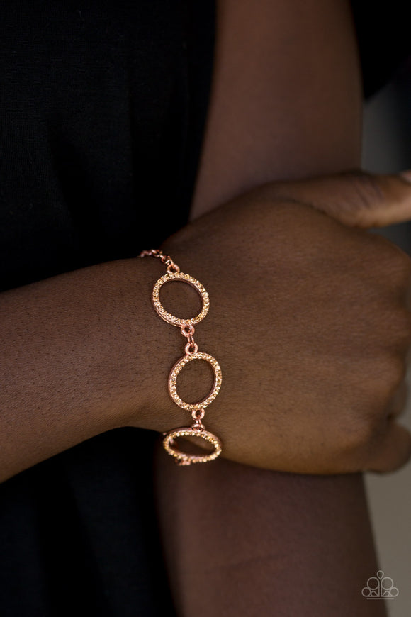 Dress The Part - Gold - Paparazzi Accessories  Encrusted in glassy rhinestones, three shiny gold rings link across the wrist for a glamorous look. Features an adjustable clasp closure.  Sold as one individual bracelet.