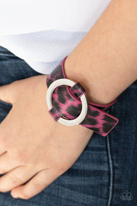 Jungle Cat Couture - Pink - Paparazzi Accessories  Featuring a shiny pink cheetah pattern, a textured piece of leather loops through the center of a shimmery silver hoop for a sassy urban look. Features an adjustable belt loop closure.  Sold as one individual bracelet.