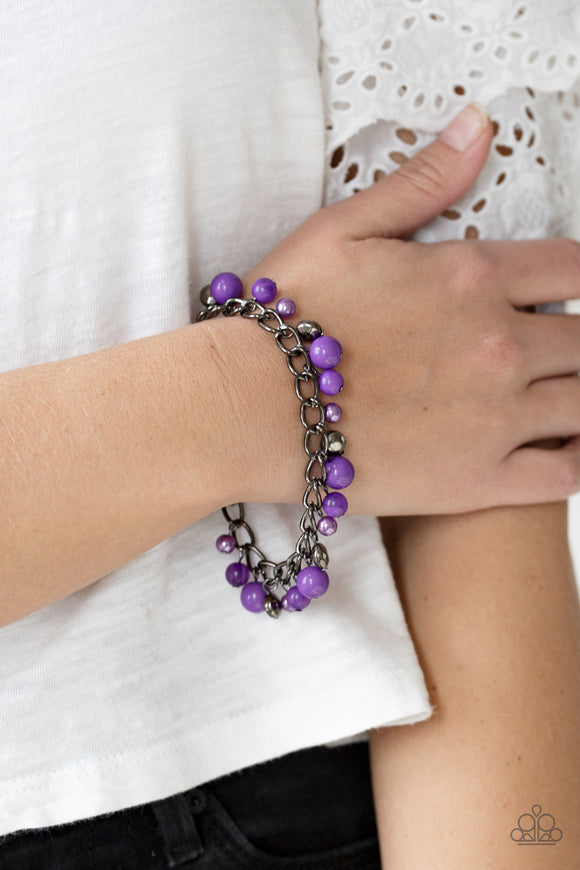 Hold My Drink - Purple - Paparazzi Accessories  Pearly and polished purple beading joins faceted gunmetal beads along a bold gunmetal chain, creating a sassy fringe around the wrist. Features an adjustable clasp closure.  Sold as one individual bracelet.   Get The Complete Look! Necklace: 