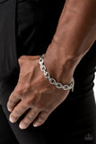 Gridiron Grunge - Silver - Paparazzi Accessories  Textured silver links are joined together with sleek silver fittings around the wrist, creating an ornate chain. Features an adjustable clasp closure.  Sold as one individual bracelet.