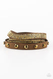 Totally Rockable - Brass - Paparazzi Accessories - An elongated strand of brown suede is encrusted in mismatched sections of glittery aurum rhinestones for a sassy look. The elongated band double wraps around the wrist for a fierce one-of-a-kind look. Features an adjustable snap closure.  Sold as one individual bracelet.