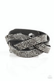 Nice Girls Finish Last - Black - Paparazzi Accessories - Item #P9DI-URBK-155XX Encrusted in row after row of glittery hematite rhinestones, three black suede bands braid across the wrist for a sassy look. Features an adjustable snap closure.  Sold as one individual bracelet.