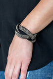 Nice Girls Finish Last - Black - Paparazzi Accessories - Item #P9DI-URBK-155XX Encrusted in row after row of glittery hematite rhinestones, three black suede bands braid across the wrist for a sassy look. Features an adjustable snap closure.  Sold as one individual bracelet.