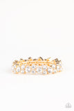 Here Comes The BRIBE - Gold - Paparazzi Accessories - Item #P9RE-GDXX-274XX Featuring sleek gold frames, trios of glittery white rhinestones are threaded along stretchy bands around the wrist for a timeless shimmer.  Sold as one individual bracelet.