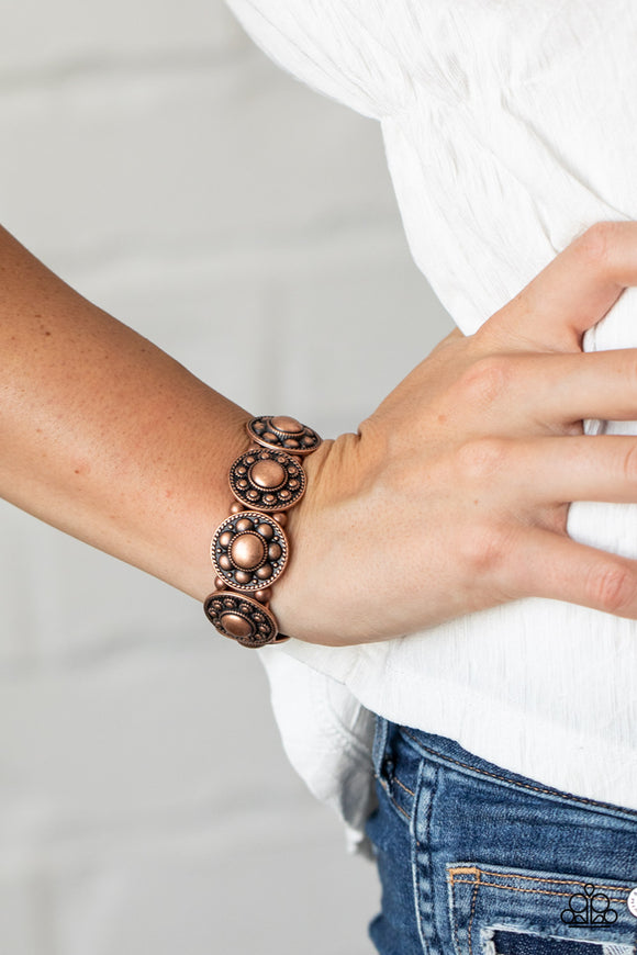 Rural Fields - Copper - Paparazzi Accessories - Item #P9BA-CPXX-036XX Studded and dotted in decorative floral patterns, antiqued copper frames are threaded along stretchy bands around the wrist for a seasonal flair.  Sold as one individual bracelet.