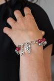 Lady Love Dove - Red - Paparazzi Accessories -  Item #P9WH-RDXX-113XX Red pearls, ornate silver beads, and white rhinestone encrusted accents swing from a dramatic silver chain. A shimmery silver bird charm and silver tassel are added to the display, creating a whimsical fringe around the wrist. Features an adjustable clasp closure.  Sold as one individual bracelet.