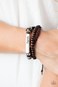 Let Faith Be Your Guide - Brown - Paparazzi Accessories - Item #P9UR-BNXX-504XX A strand of wooden beads and a braided band of brown suede flank a piece of beaded leather that features the silver frame stamped in the word, "faith," creating earthy layers around the wrist. Features an adjustable sliding knot closure.  Sold as one individual bracelet.