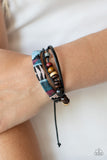 Urban Badlands - Multi - Paparazzi Accessories - Item #P9UR-MTXX-196XX A mismatched collection of wooden beads, dainty leather bands, and a decorative strand featuring a colorful textile pattern layer across the wrist for a rustic flair. Features an adjustable sliding knot closure.  Sold as one individual at DeesBlings.com - Affordable Fashion Jewelry that is Lead and Nickel free.