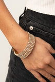 The GLOW-Digger - Gold - Paparazzi Accessories -   Item #P9RE-GDXX-285XX Encased in glistening gold fittings, row after row of glassy white rhinestones coil around the wrist, creating a blinding infinity wrap bracelet.  Sold as one individual bracelet.