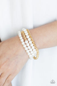 Industrial Incognito - Gold - Paparazzi Accessories -  Item #P9RE-GDXX-184XX A collection of pearly white beads and glistening gold chains are threaded along stretchy bands, creating a bold collision of industrial glamour.  Sold as one set of four bracelets.