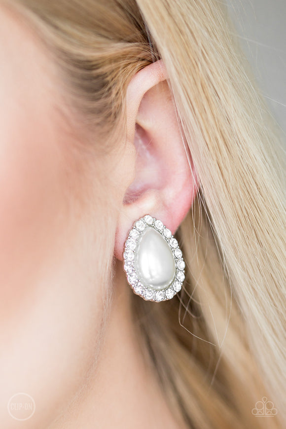 Dapper Dazzle - White Clip-On - Paparazzi Accessories -  #P5CO-WTXX-076XX  Glassy white rhinestones spin around a pearly teardrop center, creating a timeless frame. Earring attaches to a standard clip-on fitting.  Sold as one pair of clip-on earrings by DeesBlings.com - Affordable Fashion Jewelry that is Lead and Nickel free.